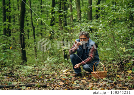 Mushroom picking. Man is in the forest at daytime Mushroom picking. Man is in the forest at daytime 139245231