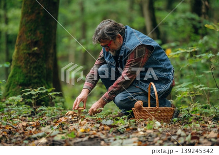 Identification if it's safe one. Mushroom picking. Man is in the forest at daytime 139245342