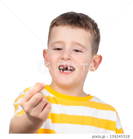 Happy child showing first lost baby tooth isolated on white background childhood milestone concept 139245528