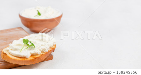 Cream cheese spread on toasted bread minimal breakfast composition with copy space 139245556