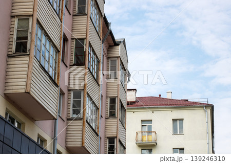 Photograph captures aged residential buildings with mismatched balconies and muted light ambiance Photograph captures aged residential buildings with mismatched balconies and muted light ambiance 139246310