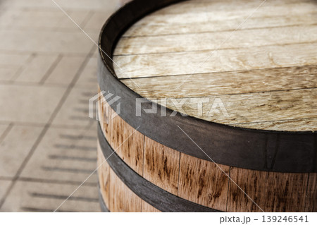 Close-up of a rustic wooden oak barrel with metal hoops Close-up of a rustic wooden oak barrel with metal hoops 139246541