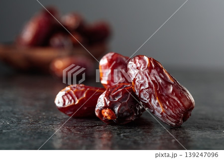 Dried dates fruit on a black table. Dried dates fruit on a black table. 139247096