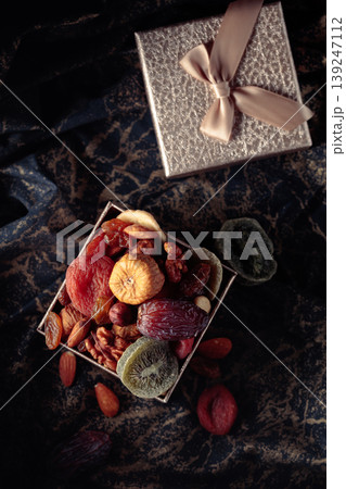 Dried tropical fruits, nuts, and raisins in gift box. Dried tropical fruits, nuts, and raisins in gift box. 139247112