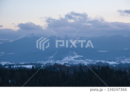 Winter evening sunset mountains (Ukraine, Carpathians -  mountain peaks scenery view from Yablunytsia Pass). 139247368
