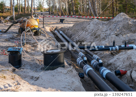 Underground insulated pipeline installation in trench for district heating infrastructure project 139247651