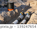 Pre-insulated pipeline with inspection chamber during district heating installation in construction trench 139247654