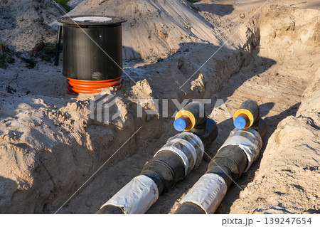 Pre-insulated pipeline with inspection chamber during district heating installation in construction trench 139247654
