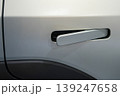 Modern white electric car door handle close-up with flush design and sleek automotive detail 139247658