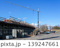 Tower crane and bridge construction site with scaffolding structure under clear blue sky view 139247661
