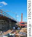 Mobile crane and bridge construction site with scaffolding under clear blue sky daylight scene 139247663