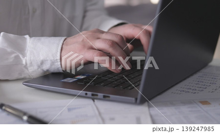Professional Focused On Financial Review While Preparing Detailed Business Documentation. Busy Analyst Intensely Reviewing Business Spreadsheets And Generating Comprehensive Reports 139247985