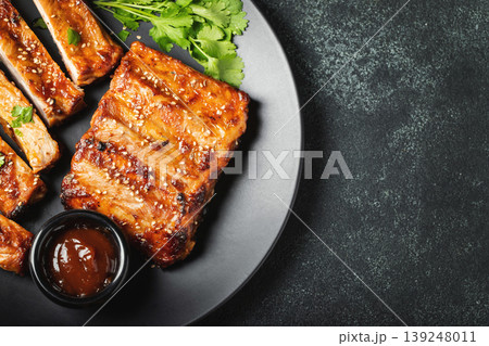 Hot grilled spare ribs from a summer BBQ served on a plate with 139248011