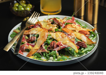 Salad with Pear, Arugula, Jamon, Blue Cheese and Blueberry, Delicious Fresh Salad Appetizer on Bright Background 139248040