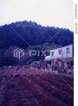 Farmer Tilling Soil Near Mountain House 139248431