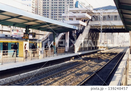 Urban Train Station Platform with Passengers and Tracks 139248457