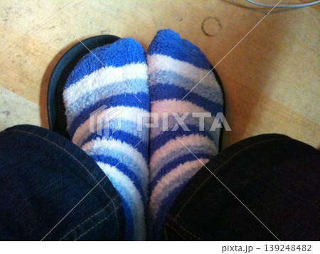 Feet in Striped Socks and Flip-Flops 139248482