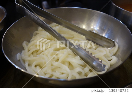 Udon Noodles in Metal Bowl with Tongs 139248722