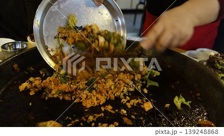 Cooking Stir-Fried Rice on a Large Pan 139248868