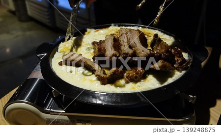Sizzling Meat and Creamy Dish in Iron Pot 139248875