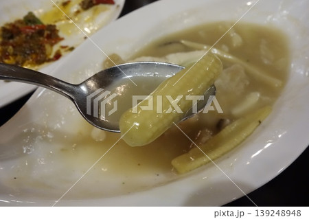 Spoon Holding Corn Kernel in Soup Dish Spoon Holding Corn Kernel in Soup Dish 139248948