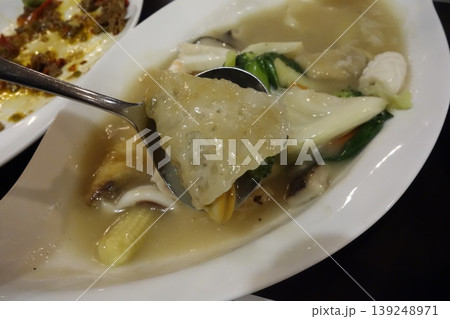 Steaming Soup with Dumplings and Vegetables 139248971