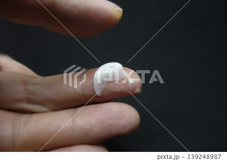 Close-up of Finger with White Substance on Nail 139248987