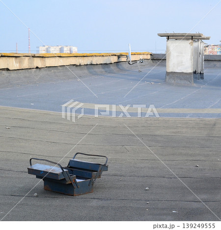 open blue metal tool box on a grey roof open blue metal tool box on a grey roof 139249555