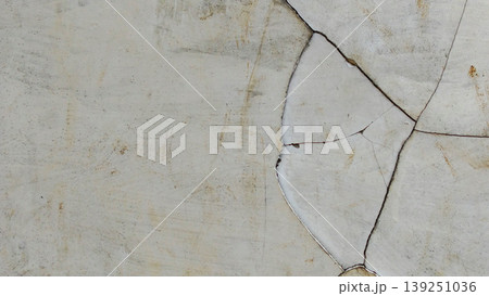 Weathered concrete or cement walls, showing visible cracks and a rough surface texture. Weathered concrete or cement walls, showing visible cracks and a rough surface texture. 139251036