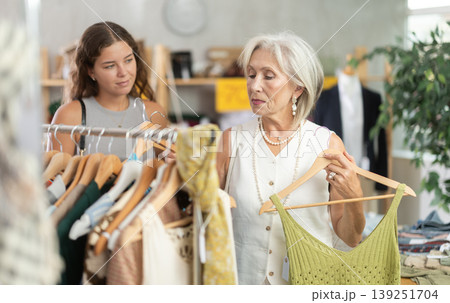 Elderly and young women choosing summer clothes in store Elderly and young women choosing summer clothes in store 139251704