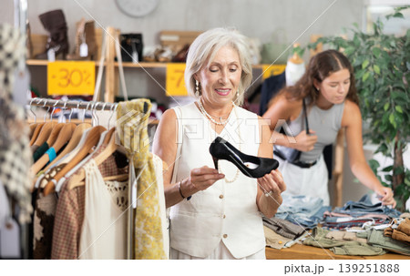 Elderly women choosing high heel shoes in store Elderly women choosing high heel shoes in store 139251888