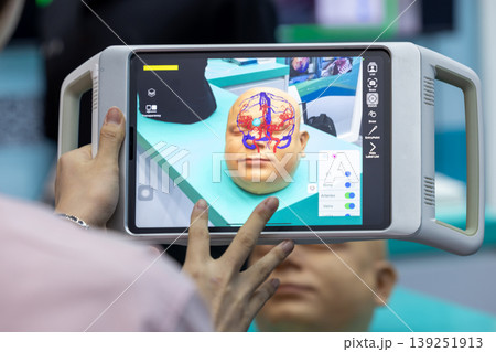 Surgeon using advanced Augmented Reality surgical navigation system on tablet visualize 3D scan, Augmented Reality AR technology in neurosurgery visualization digital. 139251913