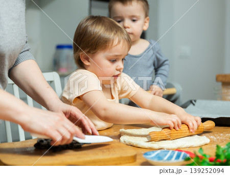 Toddler children help mom cook pizza Toddler children help mom cook pizza 139252094