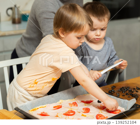 Toddler children help mom cook pizza Toddler children help mom cook pizza 139252104