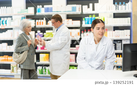 Female pharmacist in medical uniform posing while working in pharmacy Female pharmacist in medical uniform posing while working in pharmacy 139252191