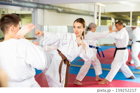 Woman sparring during group karate training 139252217