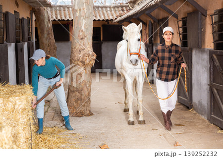 Two women horse breeders working in ranch 139252232