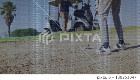 Positioning golfer in patterned pants swinging club at bunker, with ball, data overlay, copy space 139253047