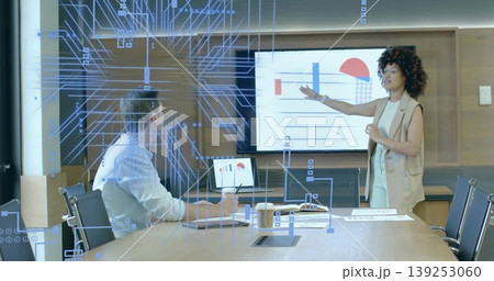 Pointing presenter in blazer explaining charts on boardroom screen with digital overlay, copy space Pointing presenter in blazer explaining charts on boardroom screen with digital overlay, copy space 139253060
