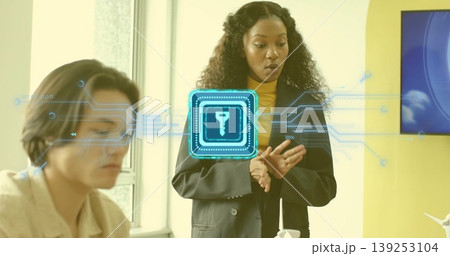 Presenting businesswoman in black blazer explaining encryption in office, with holographic key icon Presenting businesswoman in black blazer explaining encryption in office, with holographic key icon 139253104
