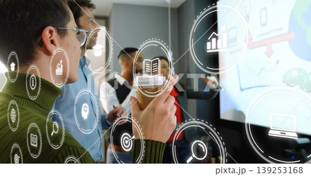 Presenting woman in green sweater holding coffee cup in conference room with tech icons, copy space 139253168