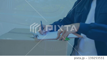Delivery man signing forms on cardboard box by van, with clipboard pen green folder, copy space Delivery man signing forms on cardboard box by van, with clipboard pen green folder, copy space 139253531