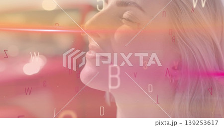 Showing close-up woman tilting head in studio, with floating letters and numbers, copy space 139253617
