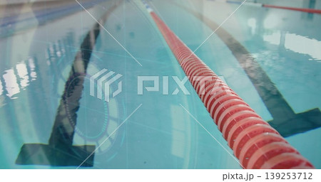 Showing red rope extending from right pool lane, with floor stripe, water reflections, copy space Showing red rope extending from right pool lane, with floor stripe, water reflections, copy space 139253712