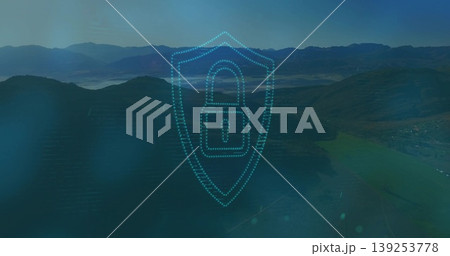 Transparent dotted-line shield graphic hovering over misty mountain valley, with padlock icon Transparent dotted-line shield graphic hovering over misty mountain valley, with padlock icon 139253778