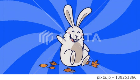 Waving floppy-eared cartoon rabbit smiling against blue spiral backdrop, with orange leaves 139253866