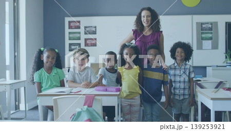 Standing teacher guiding elementary students in bright classroom, with open notebooks pencil case Standing teacher guiding elementary students in bright classroom, with open notebooks pencil case 139253921