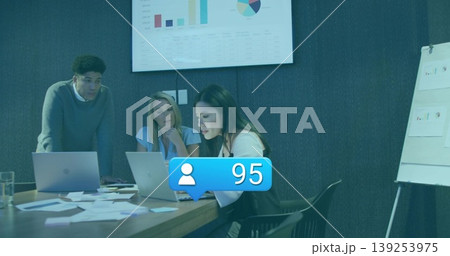 Reviewing data three professionals collaborating around conference table, with laptops and charts Reviewing data three professionals collaborating around conference table, with laptops and charts 139253975