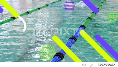 Displaying green-blue lane divider rope floating in turquoise pool water, showing black spacers Displaying green-blue lane divider rope floating in turquoise pool water, showing black spacers 139253982