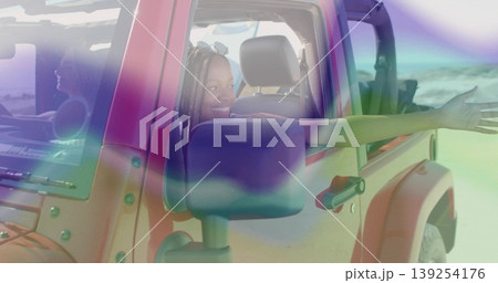 Leaning woman in summer clothes extending arm from red SUV window at sandy beach, with sunglasses Leaning woman in summer clothes extending arm from red SUV window at sandy beach, with sunglasses 139254176